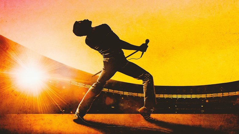 Freddie Mercury on stage at Live Aid, bathed in golden light, arms outstretched as the crowd roars