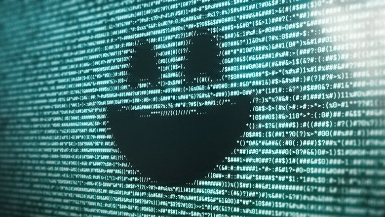 A grieving woman stares blankly at a screen in a dimly lit room