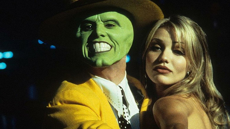 The Mask tips his yellow fedora, grinning with impossible, cartoonish teeth