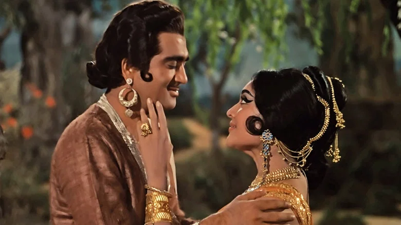 Ajatashatru, disguised as a soldier, watches Amrapali dance in the royal court, his expression caught between admiration and calculation.