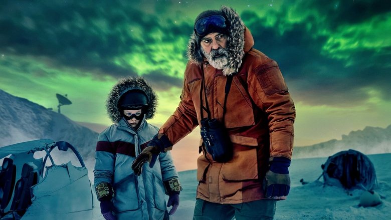 A lone figure in a red parka stands against a vast, snow-covered landscape, the Arctic station barely visible in the distance.