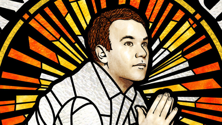 Mike Birbiglia onstage, mid-gesture, his face caught between a smile and something like panic