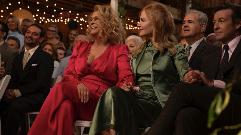 A wide, moody exterior shot of a dilapidated Victorian house surrounded by dense, overgrown woods