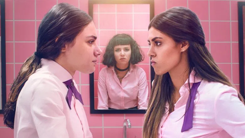 A dimly lit school hallway, students in uniform walking in pairs, their faces blurred except for one girl standing still against the lockers, her expression unreadable.