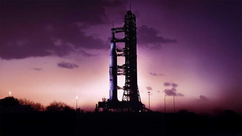 The Saturn V rocket on the launchpad, bathed in early morning light, steam hissing from its base