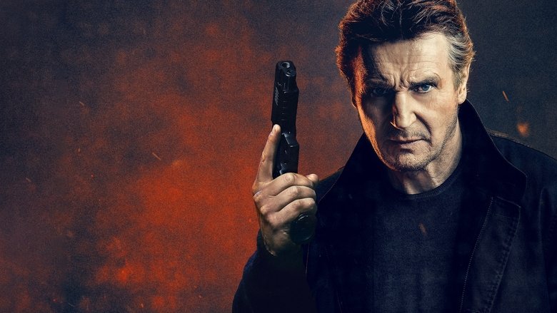 A tense standoff in a dark, industrial location, featuring Liam Neeson holding a firearm.