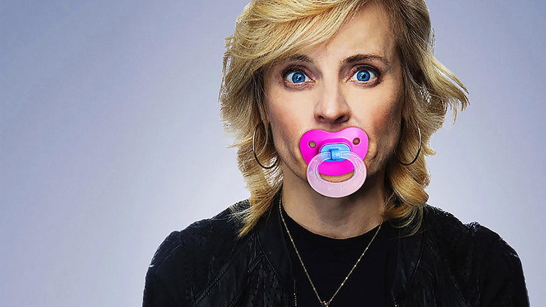 Maria Bamford mid-performance, her face contorted in an exaggerated expression, under a dim, moody light