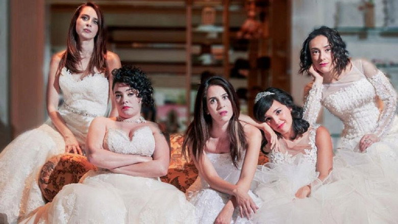 Ana, the protagonist, sits in a circle with other women in a dimly lit room, their expressions a mix of hope and exhaustion.