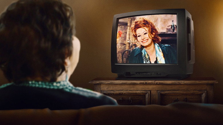 A close-up of Nancy Kulik’s hands, weathered but warm, holding a framed photo of Sophia Loren