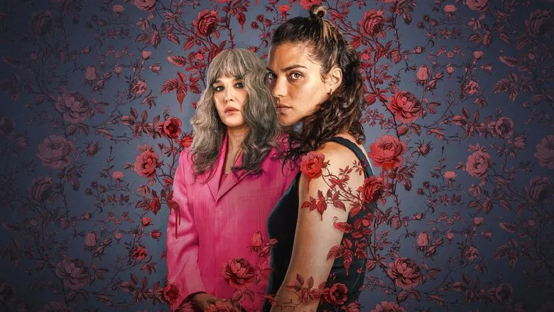 Ava Baya stands in a field of roses, her face half-lit by the harsh Provençal sun, her expression caught between defiance and exhaustion.