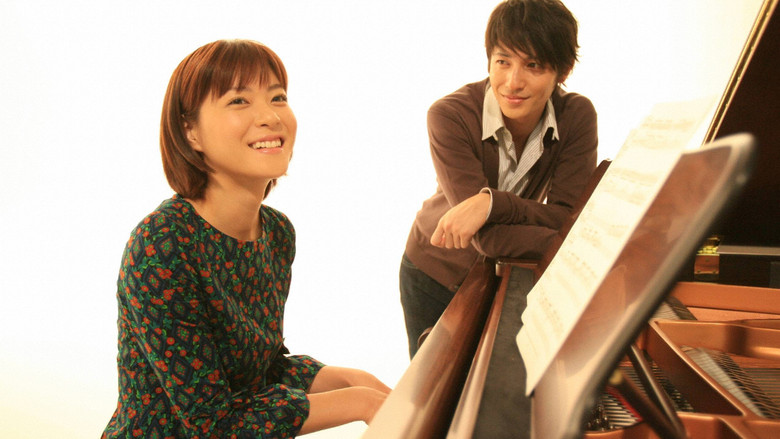 A chaotic piano lesson, with Nodame sprawled across the keys while Chiaki looms over her, exasperated.