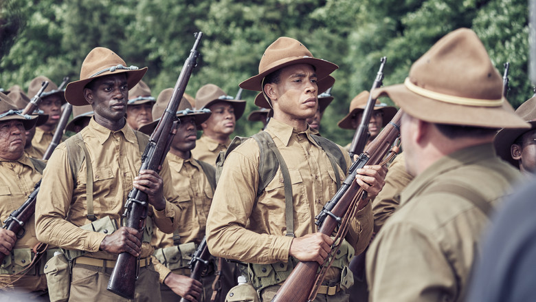 A group of Black soldiers in uniform stand in formation, their faces a mix of determination and weariness