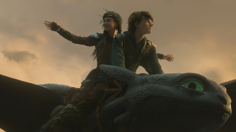 A fiery dragon battle illuminating the night sky over Berk