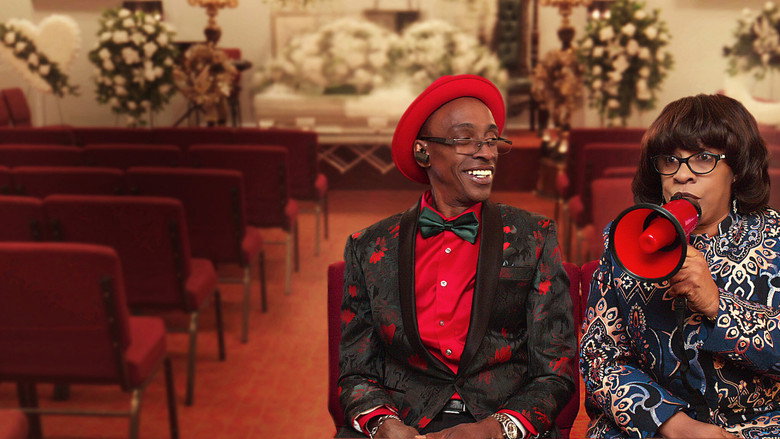 The Bernard family stands in their funeral home's chapel, surrounded by floral arrangements and soft lighting, their expressions a mix of exhaustion and warmth.