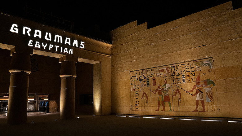 The Egyptian Theatre’s grand facade at dusk, its neon marquee glowing against the twilight