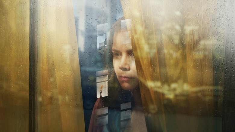 Amy Adams peers through a rain-streaked window, her face half-lit by the glow of the city outside.