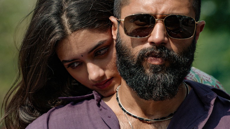 The reunion between Suri and Siva, their faces half-lit by the flickering light of a fire, the tension between them palpable even in silence.