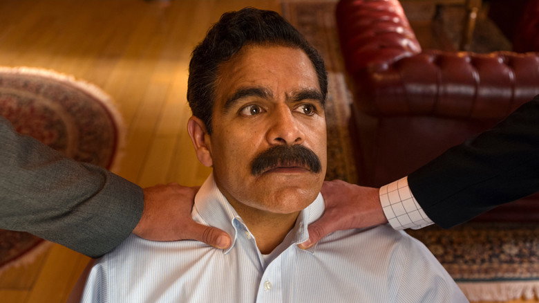José Sánchez, mid-swindle, adjusting his mustache with the gravity of a man signing a peace treaty