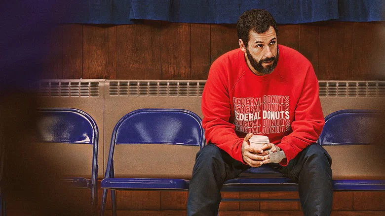 Adam Sandler and Juancho Hernangómez on a basketball court, the latter mid-dunk, their faces lit with the kind of exhausted determination that only comes from pushing past what you thought you could do.