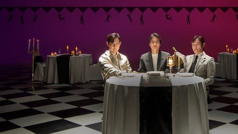 A dimly lit room where Hwang Dong-hyuk and Lee Jung-jae sit across from each other, the glow of a screen casting shadows on their faces.