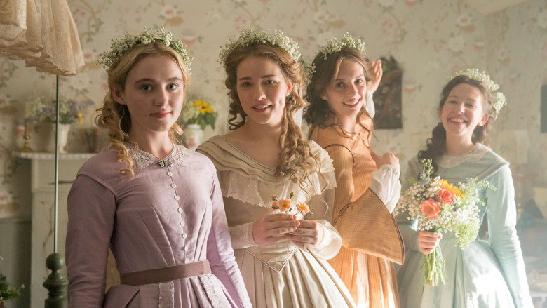 The March sisters gathered around their mother, Marmee, in a dimly lit parlor, their faces a mix of exhaustion and warmth