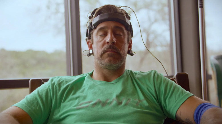 Rodgers in a dimly lit ayahuasca ceremony, steam rising around him