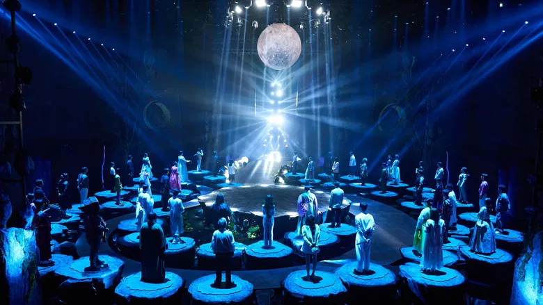 A neon-lit stage where ancient traditions meet reality television