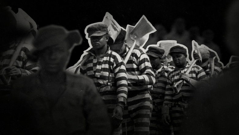 A prison yard, rows of inmates in orange jumpsuits, the camera capturing the scale of mass incarceration