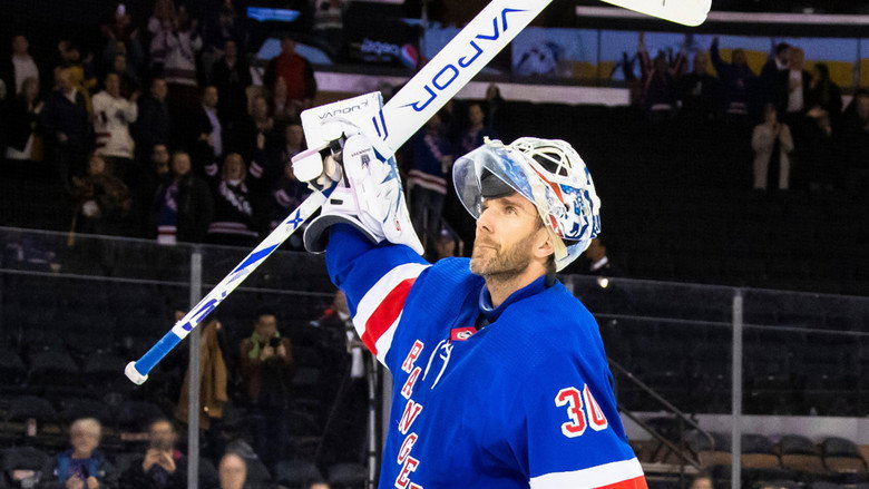 Lundqvist in full goalie gear, mid-game, his expression unreadable behind the mask