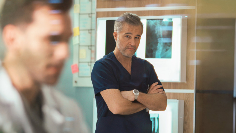 A sterile, brightly lit hospital corridor with a lone figure in a white coat looking out a window at the city skyline.