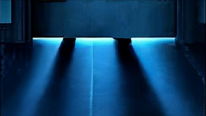 A dimly lit apartment hallway, the kind with thin walls and cheaper carpet, where every creak sounds like a footstep.