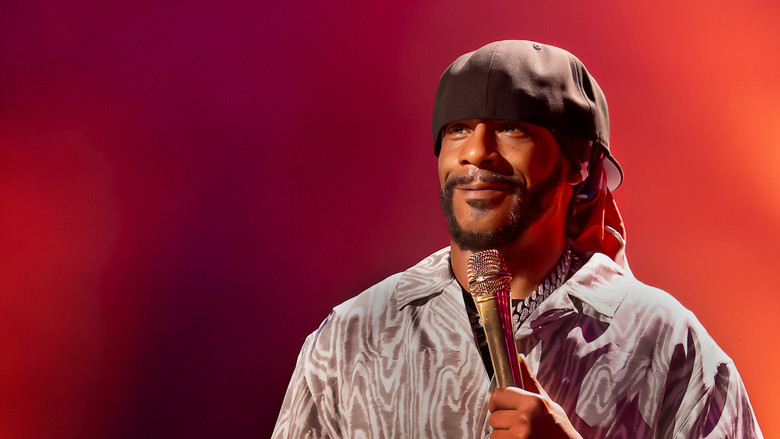 Katt Williams on stage under moody lighting