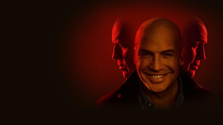 A group of students sit in a dimly lit dorm room, their faces half in shadow, as Larry Ray leans in with a smile that doesn’t reach his eyes.