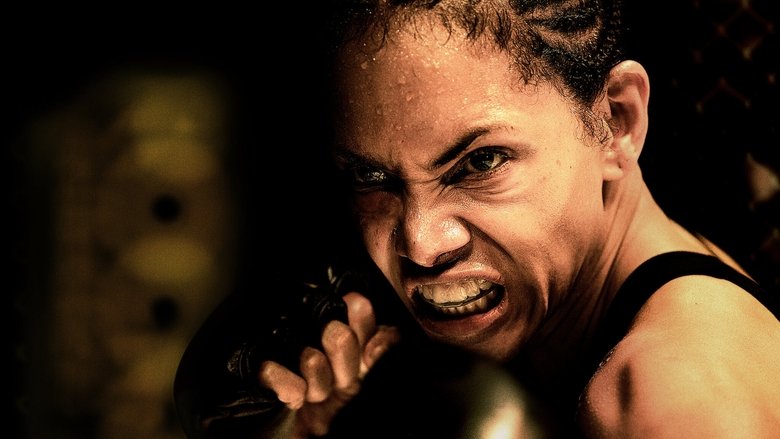 Jackie Justice in the ring, her face half-lit by the harsh overhead lights, sweat and blood streaking her skin