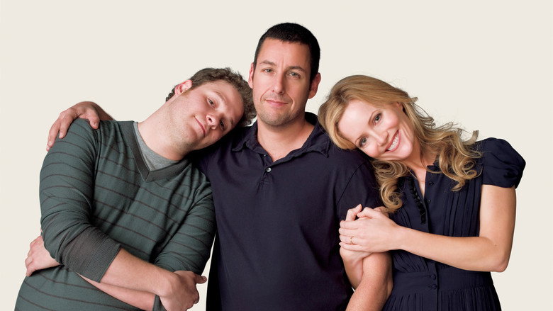 Adam Sandler and Seth Rogen sitting on a couch, the weight of the moment hanging between them