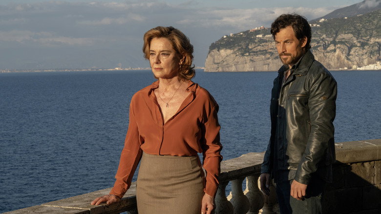 A sun-drenched terrace overlooking the Amalfi Coast, where Gabriella and Elia share a charged, silent moment—her fingers brushing his arm, his gaze lingering just a second too long.