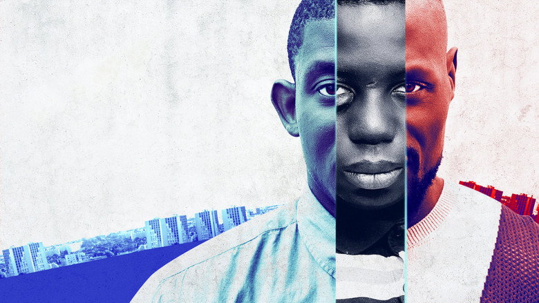 The three brothers—Demba, Soulaymaan, and Noumouké—stand in the dim glow of a streetlamp, their faces half-lit by the flicker of a passing car.