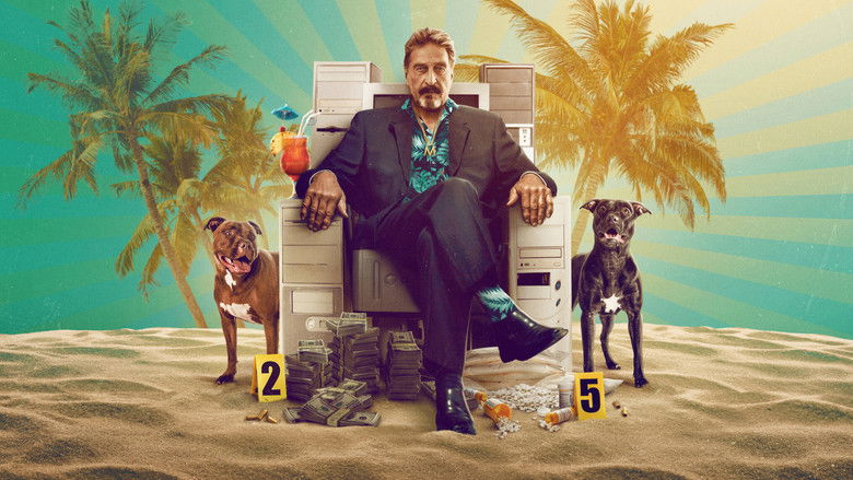 A dimly lit interview scene, John McAfee's face half in shadow, his expression tense and watchful