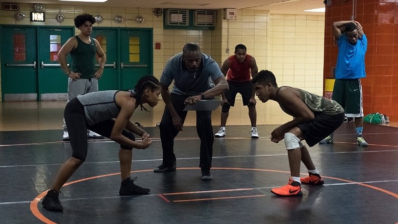 Monique in her singlet, staring down an opponent twice her size