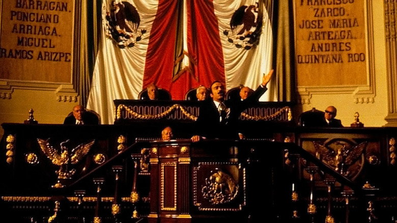 A close-up of Damián Alcázar's face, half in shadow, his expression caught between a smirk and a grimace