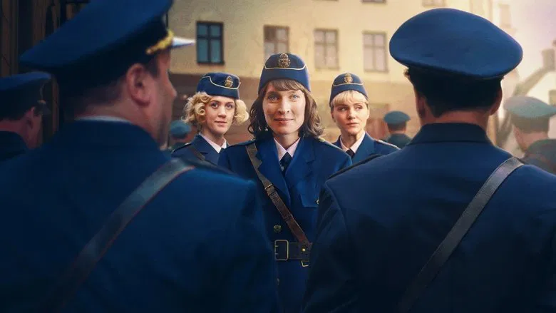 Three women in 1950s police uniforms walking down a dimly lit Stockholm street, their faces set with determination
