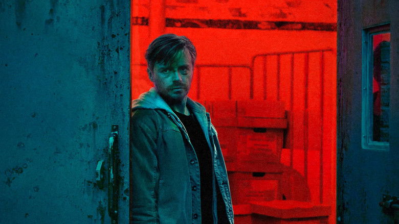 An agent looking nervously over their shoulder in a crowded transport hub