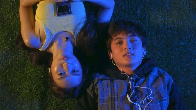 Karen and Lex share a split-screen moment, their faces framed by the glow of their respective eras