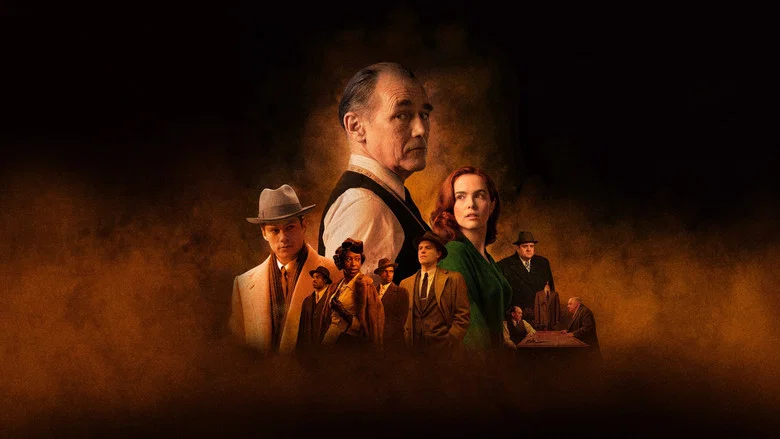 The tailor’s shop, bathed in the warm glow of a single lamp, with Leonard (Mark Rylance) standing over a half-finished suit, his scissors poised like a surgeon’s scalpel.