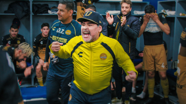 Maradona in the locker room, surrounded by players, his face lit with a rare, unguarded smile
