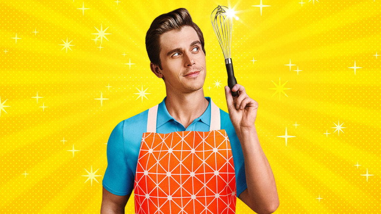 A brightly lit kitchen set, contestants in aprons huddled over stovetops, their faces tense with concentration