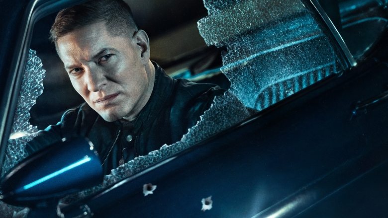 Tommy Egan stands looking over the neon-lit Chicago skyline