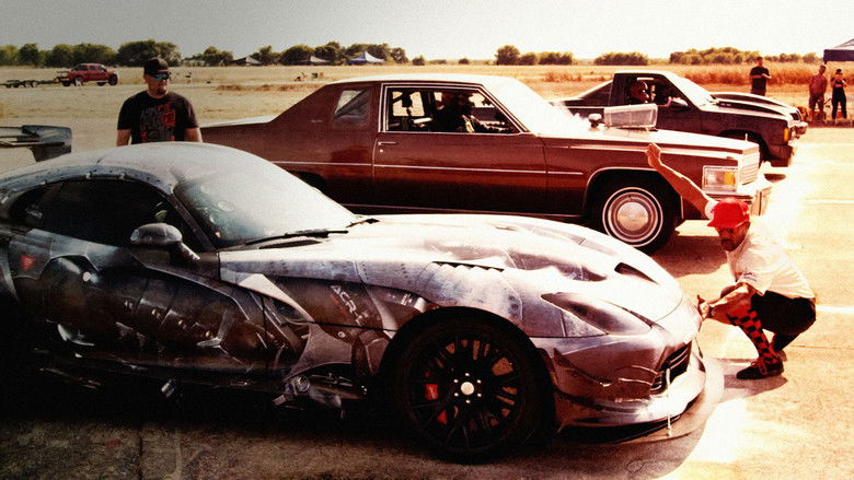 A sleeper car, unassuming in its parking lot, its hood propped open to reveal a monstrous engine