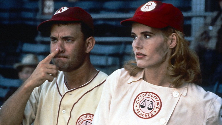 The Rockford Peaches huddle on the field, their uniforms a mix of determination and exhaustion, as the sun casts long shadows across the diamond.