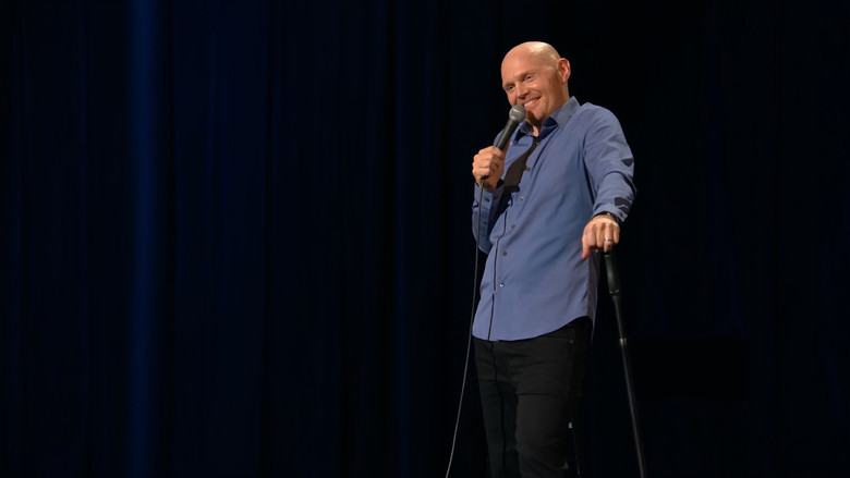 Bill Burr mid-performance, arms outstretched, face contorted in mock outrage